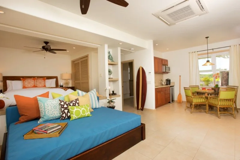 Wide view of the cottage bedroom, dining table and punee
