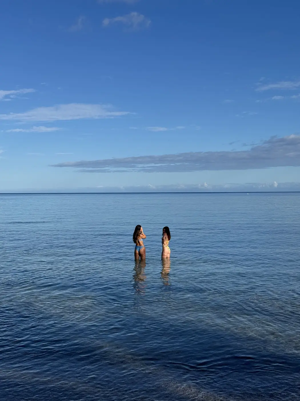 Two guests swimming in the calm water of Anaeho'omalu Bay